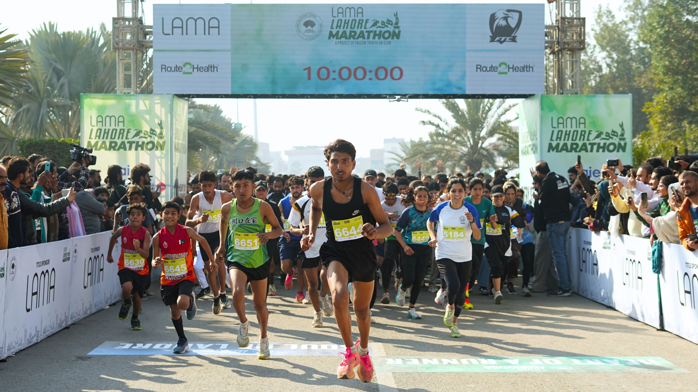Runners massed under the Lahore Marathon start arch before the flag off