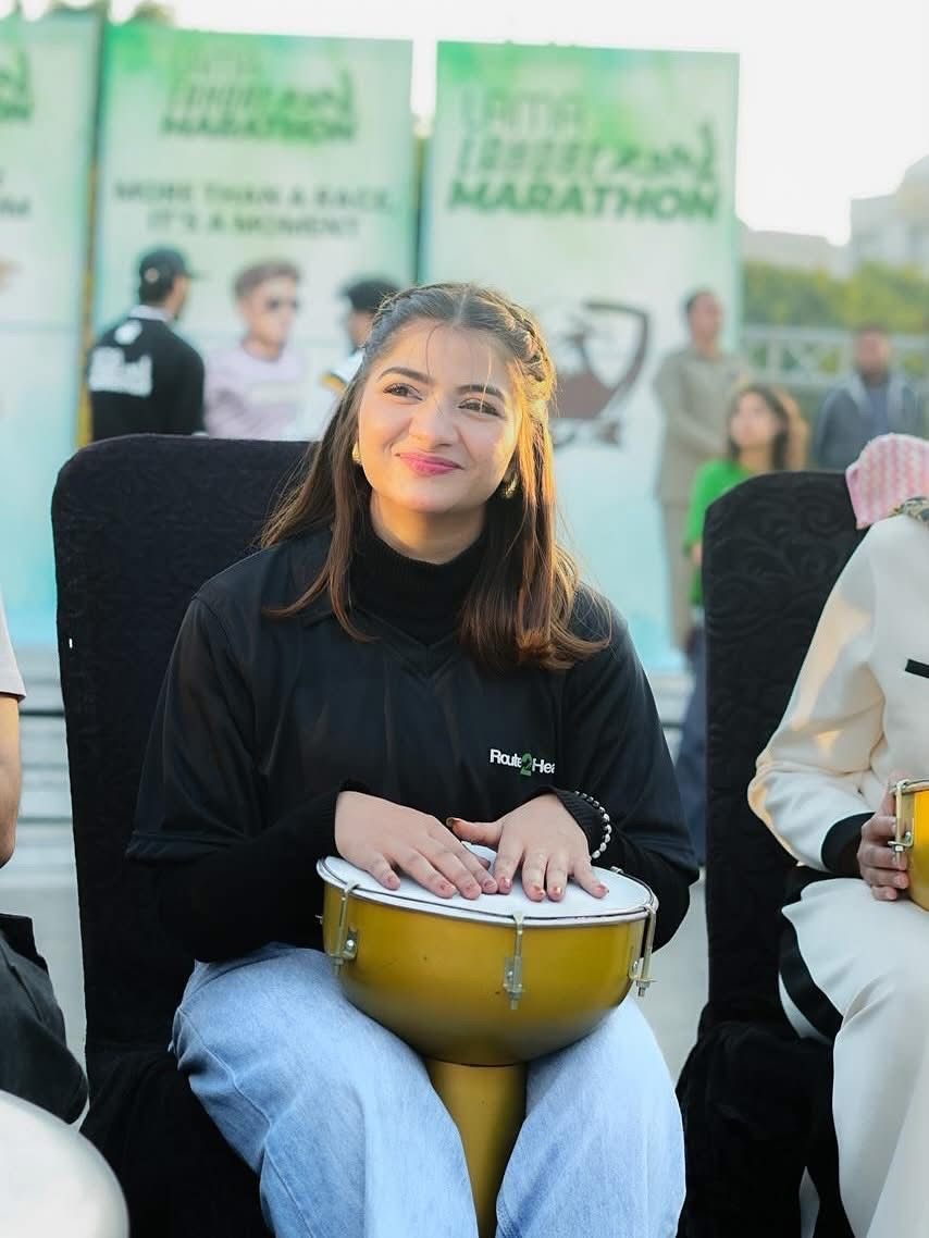 A woman playing a drum at the Marathon Village